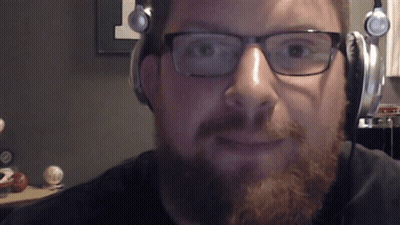 A Man With A Beard Wearing Headphones And Glasses GIF