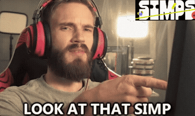 A Man With A Beard Wearing Headphones And Pointing At A Computer Screen With The Words Look At That Simp Below Him GIF