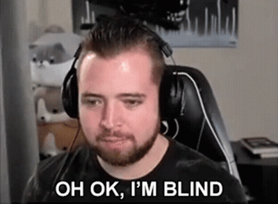 A Man With A Beard Wearing Headphones Is Sitting In Front Of A Computer Screen . GIF