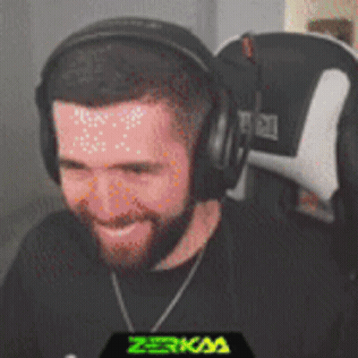 A Man With A Beard Wearing Headphones Is Smiling GIF