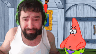 A Man With A Beard Wearing Headphones Stands Next To A Cartoon Character Patrick Star GIF