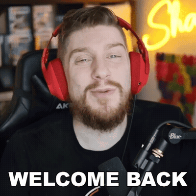 A Man With A Beard Wearing Red Headphones Says Welcome Back GIF