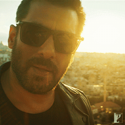 A Man With A Beard Wearing Sunglasses And A Black Shirt GIF