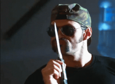 A Man With A Beard Wearing Sunglasses And A Camouflage Hat Says You Never Leave A Man Behind GIF