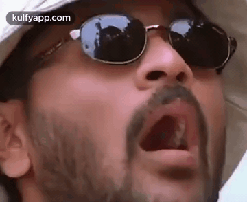 A Man With A Beard Wearing Sunglasses And A Hat . GIF