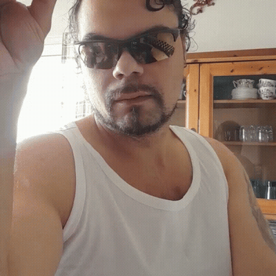 A Man With A Beard Wearing Sunglasses And A Tank Top GIF