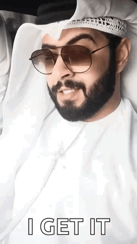 A Man With A Beard Wearing Sunglasses And A Turban Says I Get It . GIF