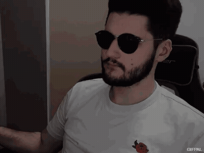 A Man With A Beard Wearing Sunglasses And A White Shirt With A Strawberry On It GIF