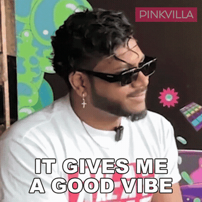 A Man With A Beard Wearing Sunglasses And Earrings Says It Gives Me A Good Vibe GIF