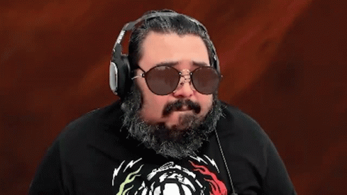 A Man With A Beard Wearing Sunglasses And Headphones With The Word Ok On His Shirt GIF