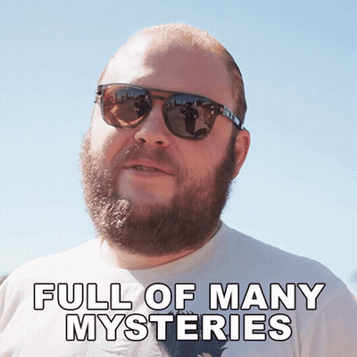 A Man With A Beard Wearing Sunglasses Has The Words Full Of Many Mysteries Below Him GIF