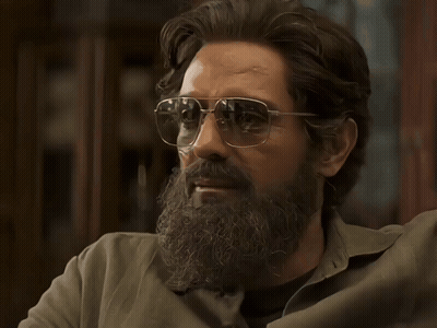 A Man With A Beard Wearing Sunglasses Looks To The Side GIF