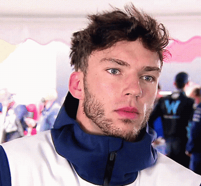 A Man With A Beard Wears A Blue Jacket With The Letter W On The Back GIF