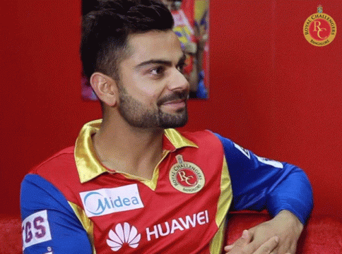 A Man With A Beard Wears A Red And Blue Shirt That Says Midea And Huawei GIF