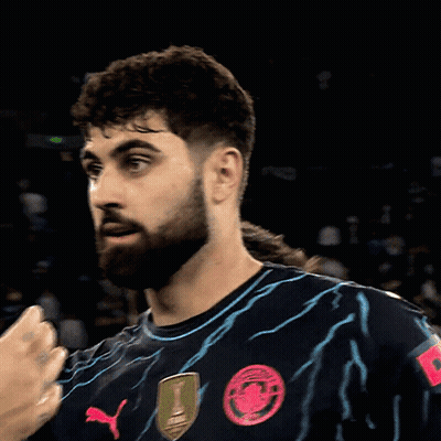 A Man With A Beard Wears A Shirt That Says Ah On The Shoulder GIF