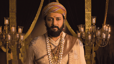 A Man With A Beard Wears A Turban And Pearl Necklace GIF