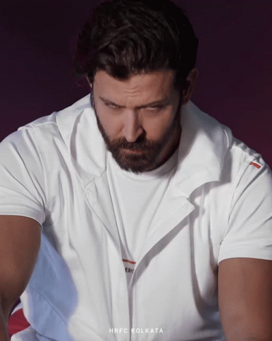 A Man With A Beard Wears A White Shirt That Says Hrfc Kolkata GIF