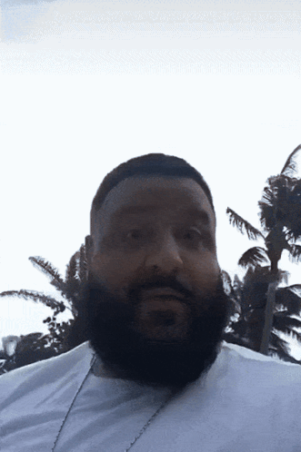 A Man With A Beard Wears A White Shirt GIF
