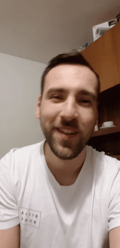 A Man With A Beard Wears A White T-Shirt That Says Ajiji Shob On It GIF