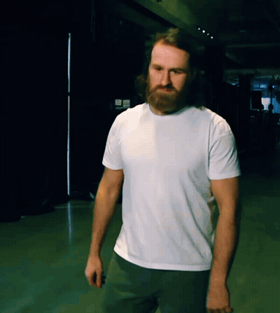 A Man With A Beard Wears A White T-Shirt GIF