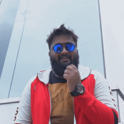 A Man With A Beard Wears Sunglasses And A Watch GIF