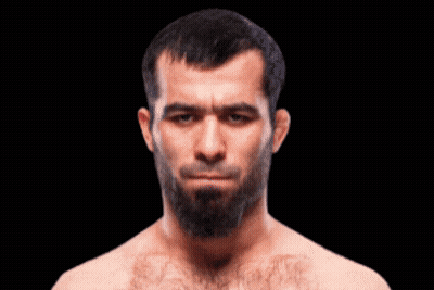 A Man With A Beard Without A Shirt Is Looking At The Camera GIF