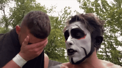 A Man With A Black And White Face Paint Covering His Face GIF