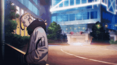 A Man With A Braided Ponytail Is Standing In Front Of A Building GIF