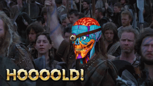 A Man With A Brain On His Head Stands In Front Of A Crowd With The Words Hooooold Written On The Bottom GIF