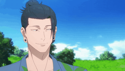 A Man With A Bun On His Head Stands In A Field With Trees In The Background GIF