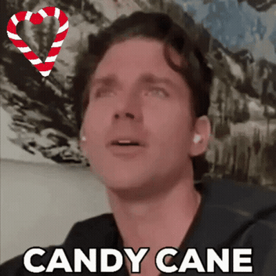 A Man With A Candy Cane In The Background GIF