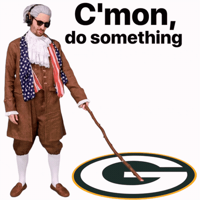 A Man With A Cane Is Standing In Front Of A Packers Logo GIF