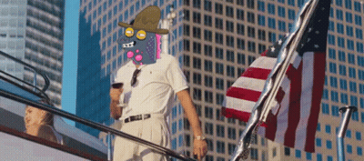 A Man With A Cartoon Face On His Face Is Standing On A Staircase Next To An American Flag GIF