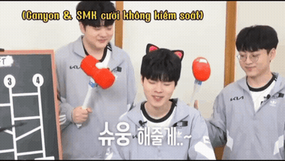 A Man With A Cat Ear On His Head Holds A Red Ball In His Hand GIF