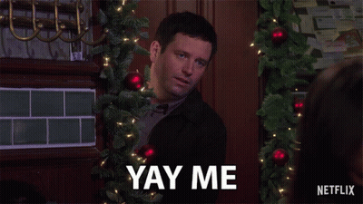 A Man With A Christmas Tree In The Background Says Yay Me GIF