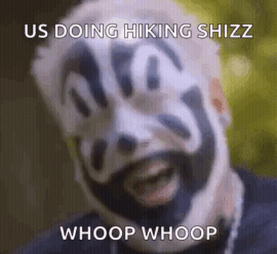 A Man With A Clown Face Painted On His Face Is Smiling . GIF