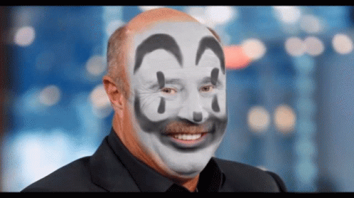 A Man With A Clown Face Painted On His Face Smiling GIF