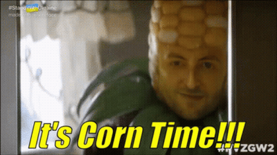A Man With A Corn On The Cob On His Head Says " It 'S Corn Time " GIF