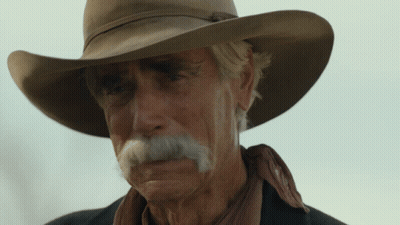 A Man With A Cowboy Hat And A Mustache Looks At The Camera GIF