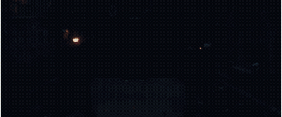 A Man With A Cross On His Back Is Holding A Torch GIF