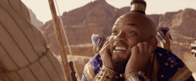 A Man With A Crown On His Head Is Smiling GIF