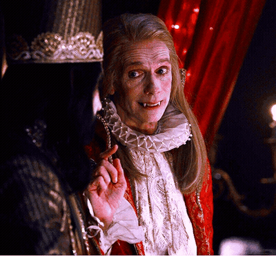 A Man With A Crown On His Head Is Talking To Another Man GIF