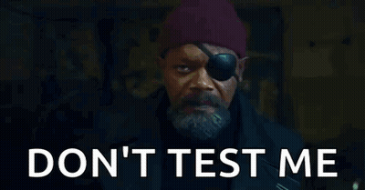 A Man With A Eye Patch And A Beard Is Standing In Front Of A Door . GIF
