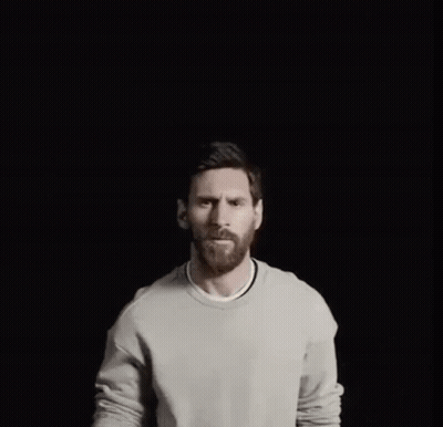A Man With A Gold Crown On His Head Points Up GIF