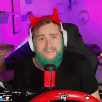 A Man With A Green Beard Is Wearing Headphones And A Red Headband With Horns GIF