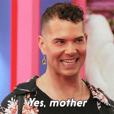 A Man With A Green Earring Is Smiling And Says " Yes Mother " GIF