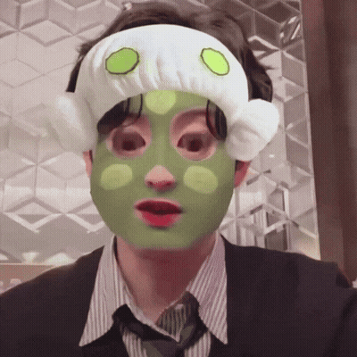 A Man With A Green Mask On His Face And A White Headband GIF