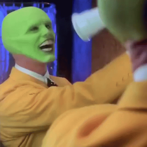 A Man With A Green Mask On His Face Is Laughing GIF