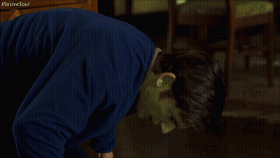 A Man With A Green Mask On His Face Is Looking At The Camera GIF
