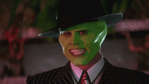 A Man With A Green Mask On His Face Is Wearing A Hat GIF